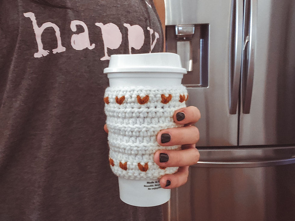 The Crochet Tiny Heart Cozy on a Starbucks mug.