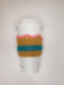 The competed crochet crown coffee cozy with three colors.