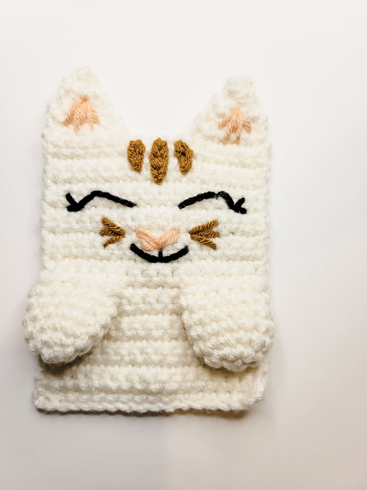 Adding the mouth on the crochet kitty cat cuddler.