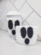 Two crochet ghost cozies, one on a reusable coffee mug.