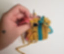 Stitching up the seam while making the crochet crown coffee cozy.