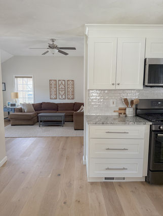 Wide plank white oak in kitchen flowing into the livingroom.