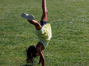 Child performing a cartwheel