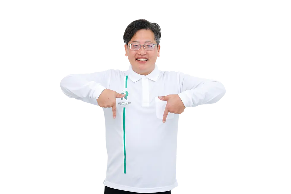 Studio photography of a smiling man in a white polo shirt pointing down with both hands. He looks friendly and engaging.