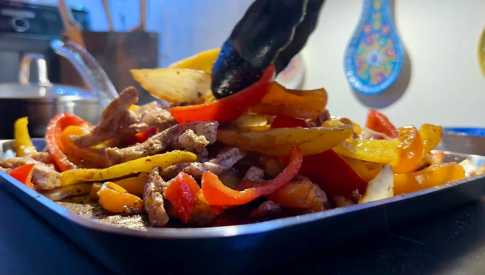 Photo of final product, chicken fajitas with onion and bell pepper slices.