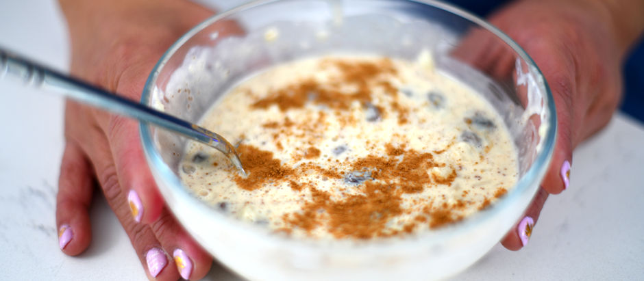 Hands holding a bowl of arroz con leche (Mexican rice pudding)