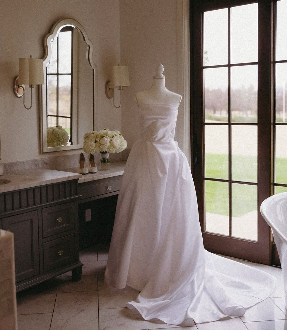 White wedding dress on mannequin in room with vanity