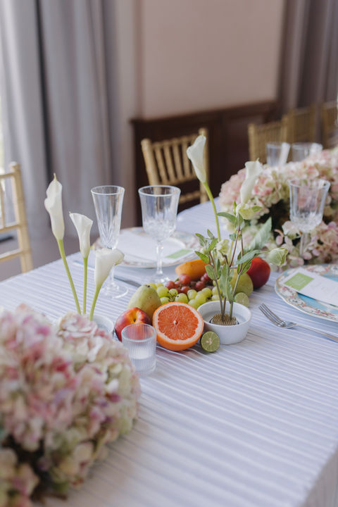 Table set with flowers and fresh fruit