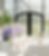 Event table with white seating, purple flowers, and arched windows