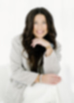 Smiling woman with long dark hair wearing a blazer