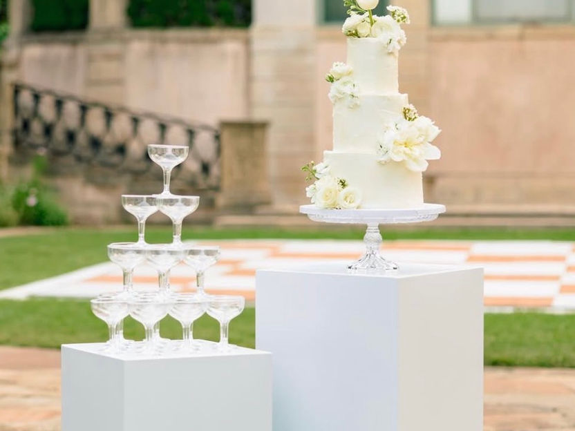 Cake stand and champagne tower with florals sitting below