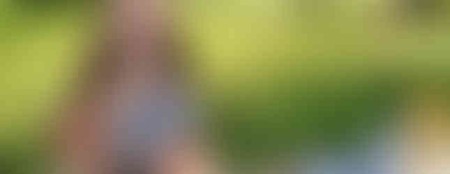 Girl eating lunch at a picnic table.