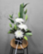 black pot of white flowers
