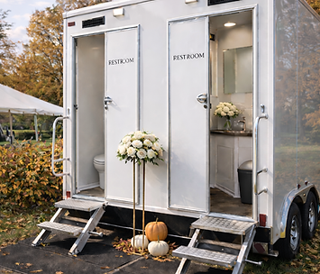 Two-stall luxury restroom trailer with open doors at an outdoor wedding, showing a clean, upscale interior in West Michigan