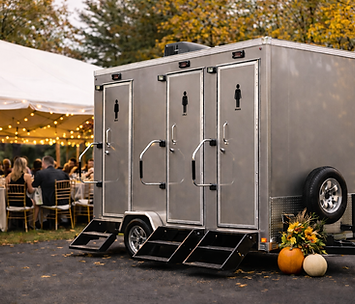 Luxury restroom trailer set up beside an outdoor wedding tent, providing upscale restroom access for guests in West Michigan