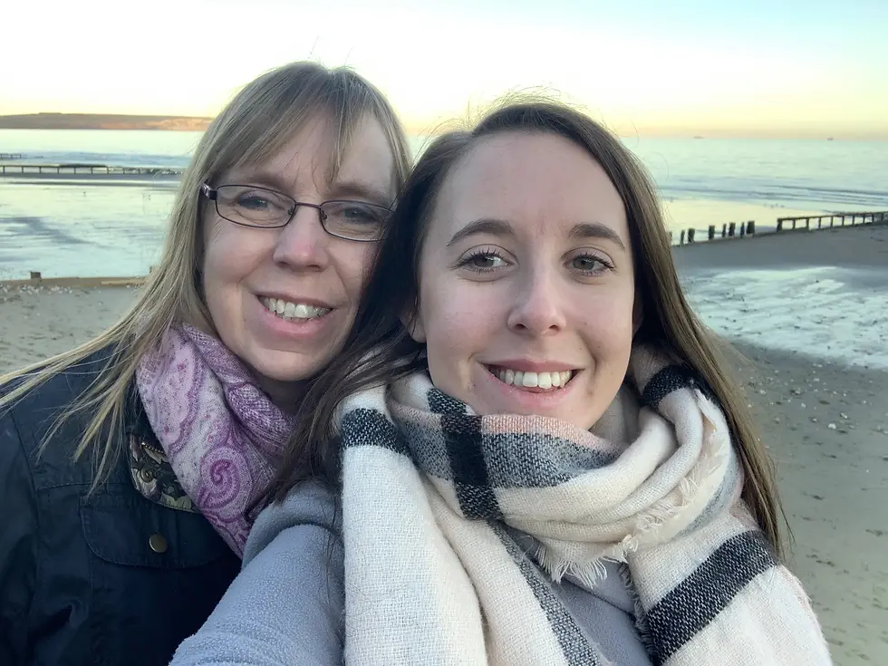 Rheanna and her mum enjoying a walk on the beach