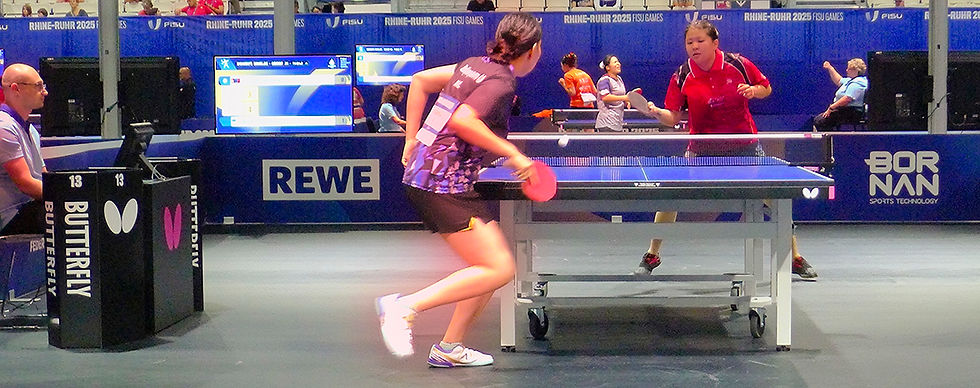 Above: NYU's Anastasia Wang (red) in a women's singles match. Below. Men's coach and the NYU table tennis team coach with some of the men's team players. Photo credits - Leon Libin