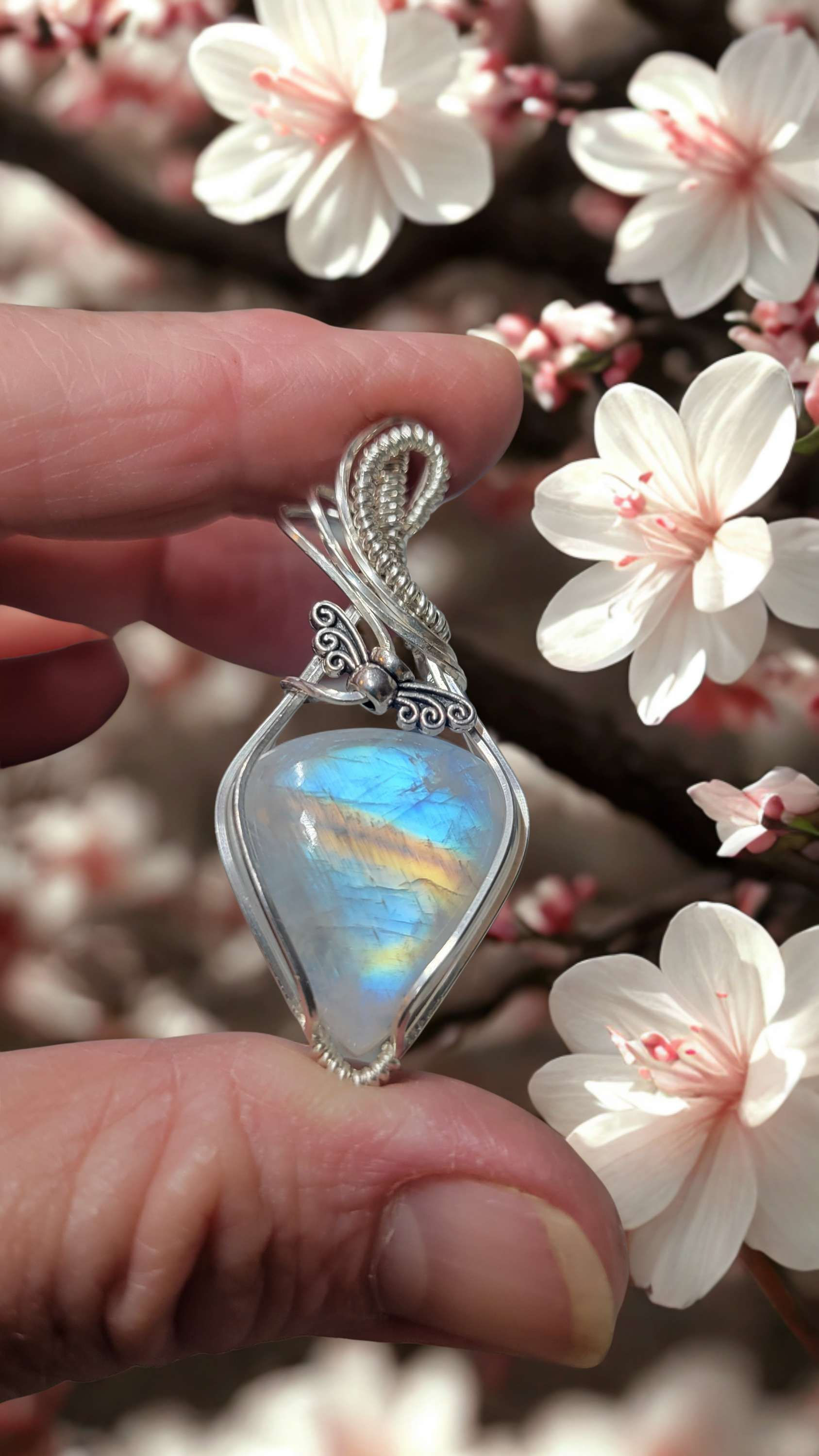 Rainbow moonstone wrapped in sterling silver and includes an 18-inch sterling si