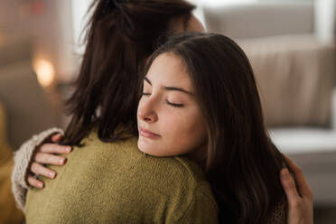 A young woman hugging her mother