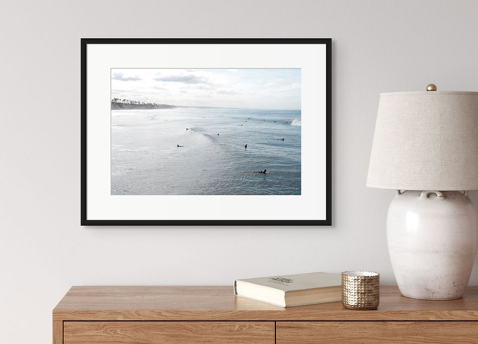 Thumbnail: A framed photograph of surfers in the morning light off the coast of Oceanside, California.
