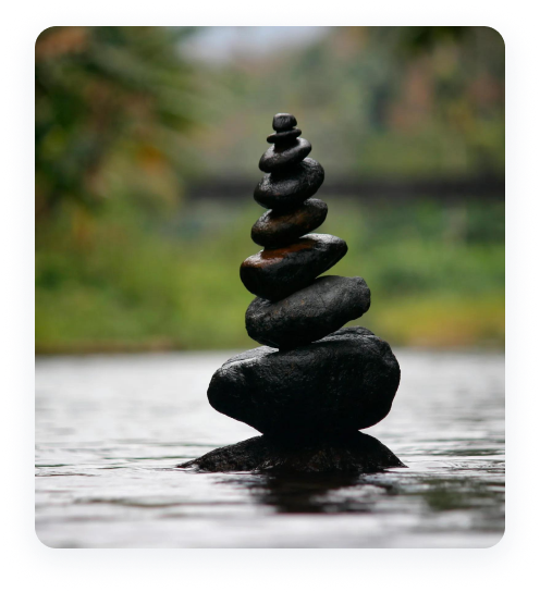 Stacked zen stones by peaceful water
