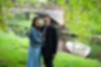 Couple holding each other in front of a river