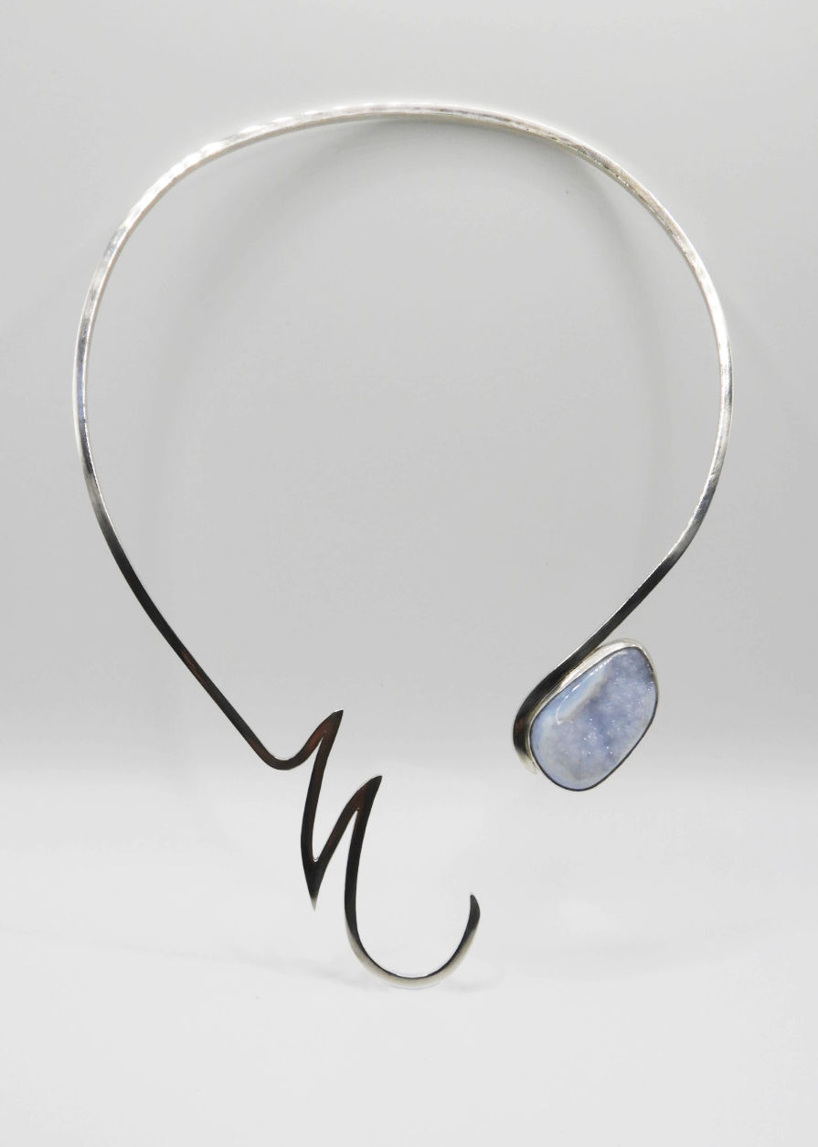 A statement silver necklace with light blue druzy chalcedony agate
