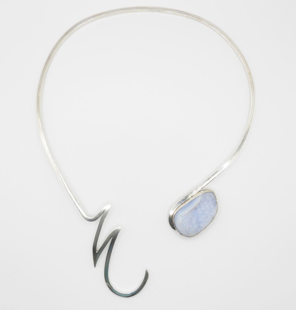 A statement silver necklace with light blue druzy chalcedony agate