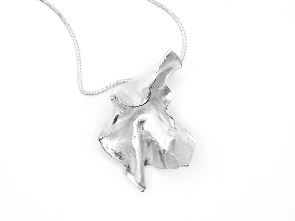 Sculpture statement silver pendant with move textile theme