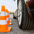 A driving instructor is setting up driving cones for parallel parking