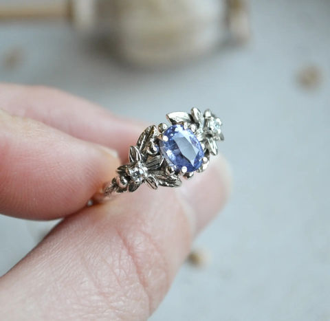 White gold and sapphire engagement ring with leaves and flowers