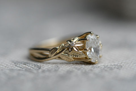 Gold vine and flower ring with oval diamond.