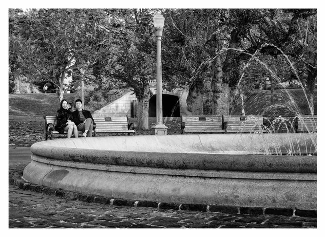 Black and white fine art photograph of a scene in San Francisco, CA, Golden Gate Park, with a couple enjoying the view of a water fountain by Alfred Hodgson