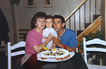 With my parents, celebrating my first year of life, July 1993.