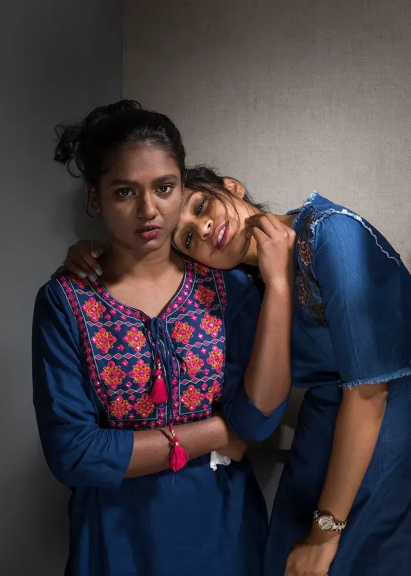 young woman resting her head on other womans shoulder