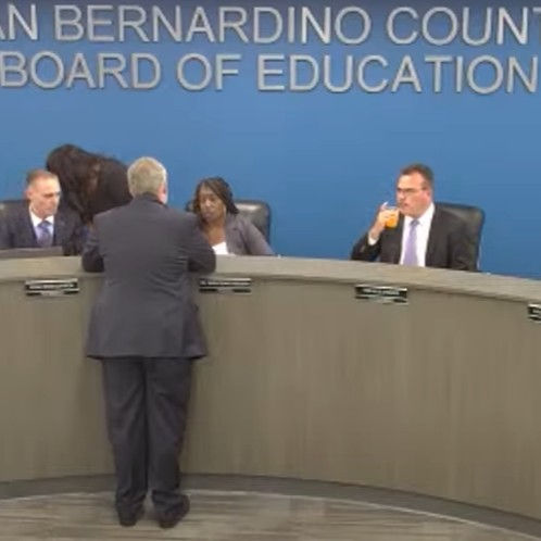 President Gwen Dowdy-Rodgers confers with attorney regarding a tripod camera. (Screenshot from County Board of Education video.)