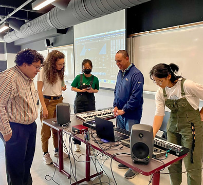 Photo of Jay allowing the University of Western Ontario students to try some of his accessible kit just after his presentation.