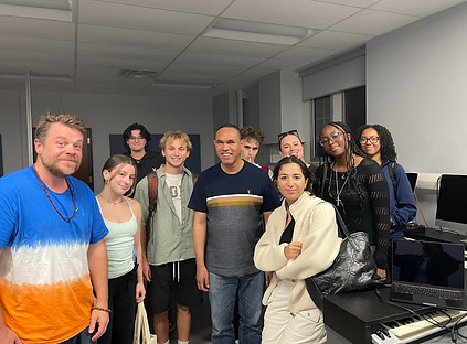 Photo of Jay surrounded by University of Werstern Ontario students and lecturer, Jay Hodgson.