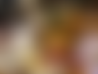 A beautiful charcuterie plate of gourmet meats and cheeses next to a glass of white wine.