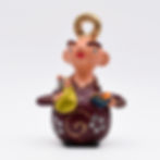 A small figurine of Saint Anthony, the patron saint of Lisbon Portugal. It has a modern, caricature-like aesthetic.