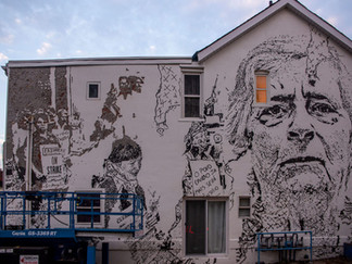 Vhils mural in Toronto, CA, of a Portuguese woman who was part of the Cleaners' Action Movement