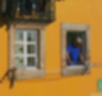 A man looks out his window in Portugal