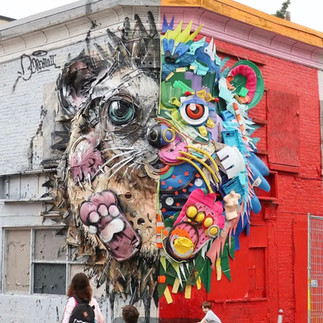 hedgehog sculpture mounted on the corner of a building. It entirely created from plastic trash by street artist bordallo ii. Half is colorful and half is more natural in tone.