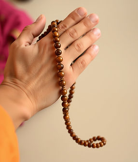 mala on someone's hand doing japa according to the Hindu tradition.jpg
