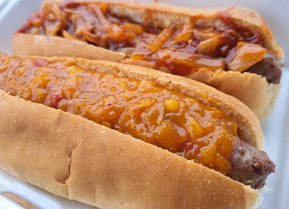 Close-up view of a boerewors roll topped with peach chili chutney