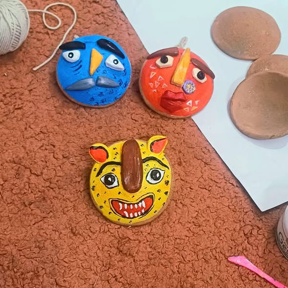 Eye-level view of a traditional wooden mask from the Duars region displayed on a rustic wall