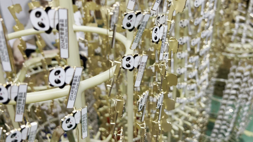 A metal badge being electroplated in a factory.