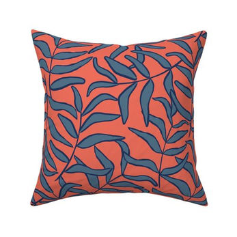 coral pillow with navy blue leaf pattern modern coastal botanical