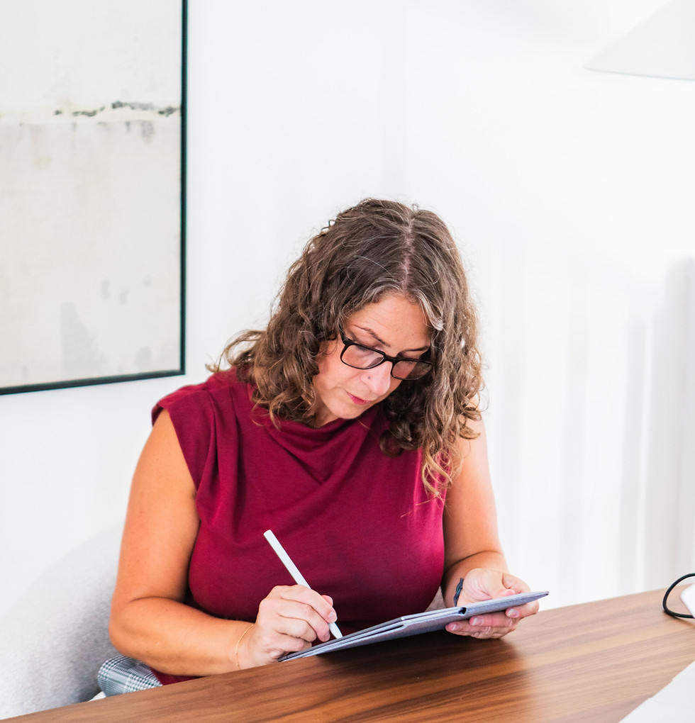 Leadership coach Zoë Thompson working at her desk