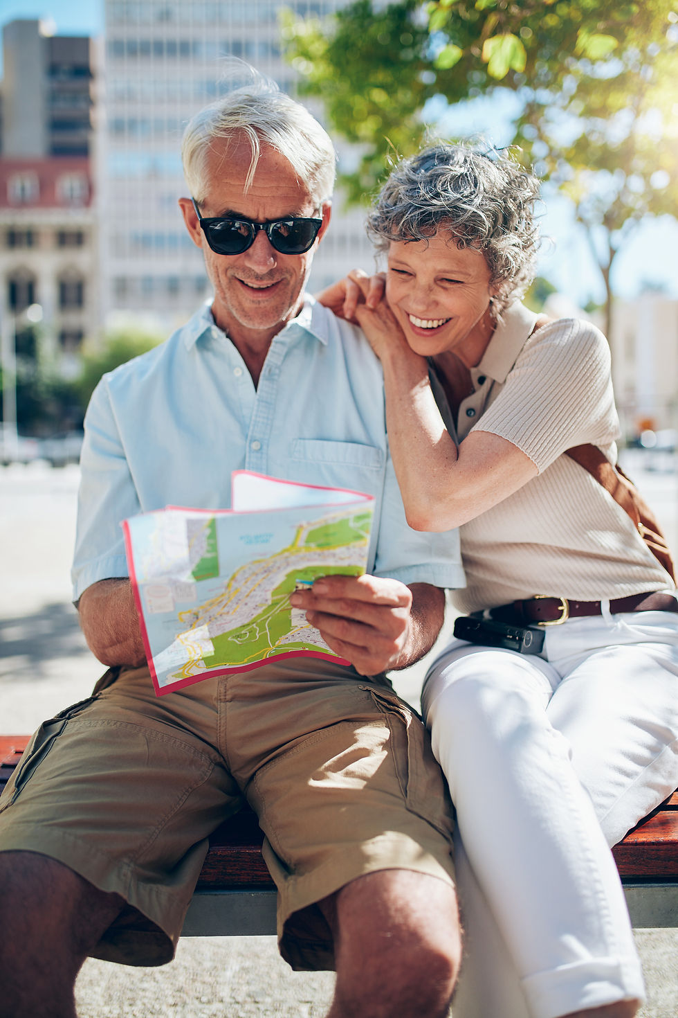 Older couple traveling looking at map